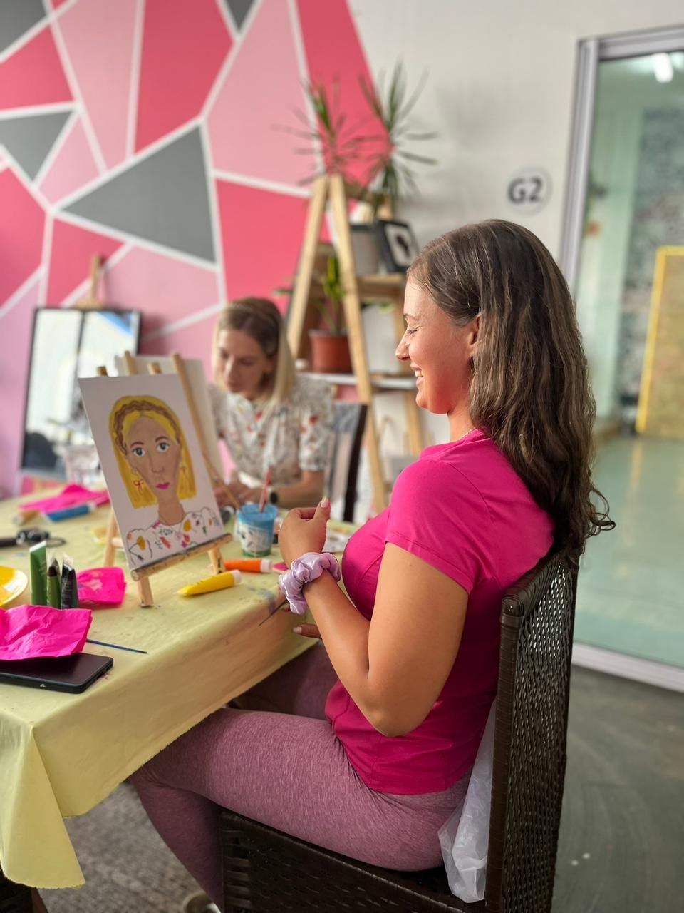 Guest smiling while painting