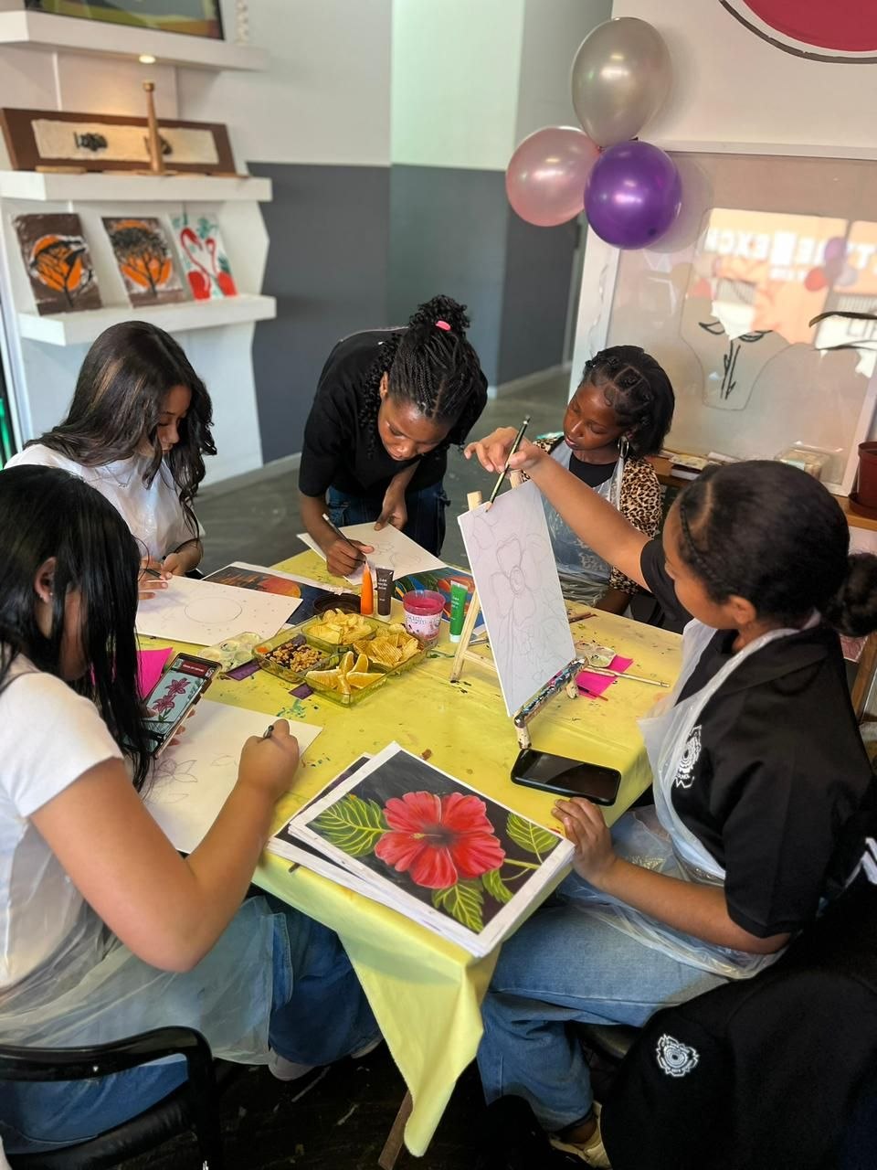 Guests painting together around a table