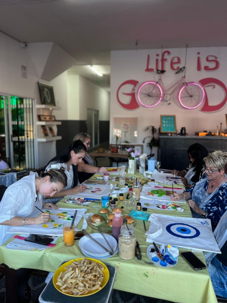 Group tote bag painting session at Life Is Good Café